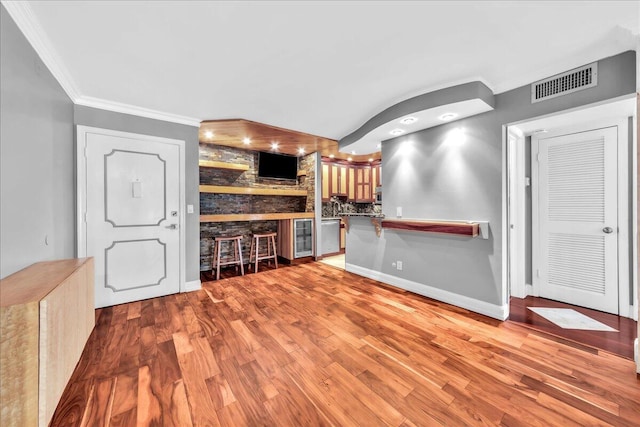 kitchen featuring light hardwood / wood-style flooring and ornamental molding