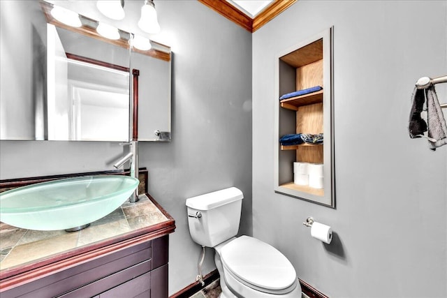 bathroom featuring crown molding, vanity, and toilet