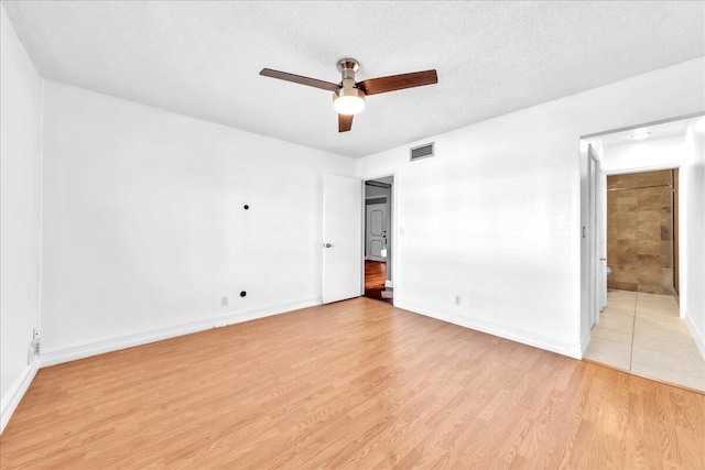 unfurnished bedroom with ceiling fan, a textured ceiling, and light wood-type flooring