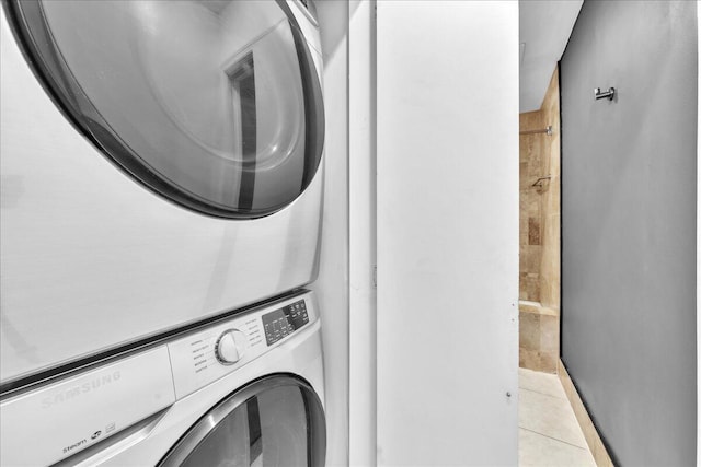 laundry room with light tile patterned floors and stacked washer and clothes dryer