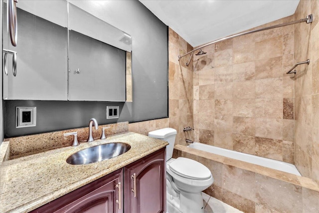 full bathroom featuring vanity, toilet, and tiled shower / bath