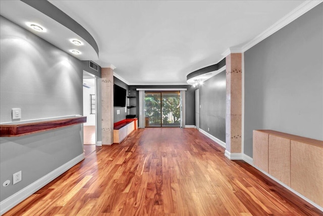 hall with crown molding and light hardwood / wood-style flooring