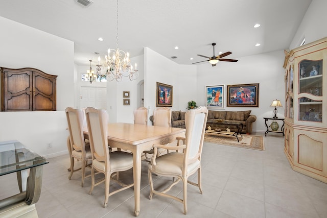 dining room featuring ceiling fan with notable chandelier and light tile patterned flooring