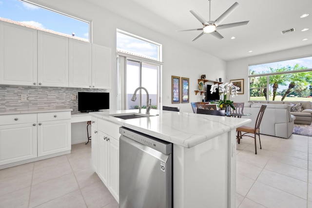 kitchen with dishwasher, white cabinetry, a kitchen island with sink, and sink