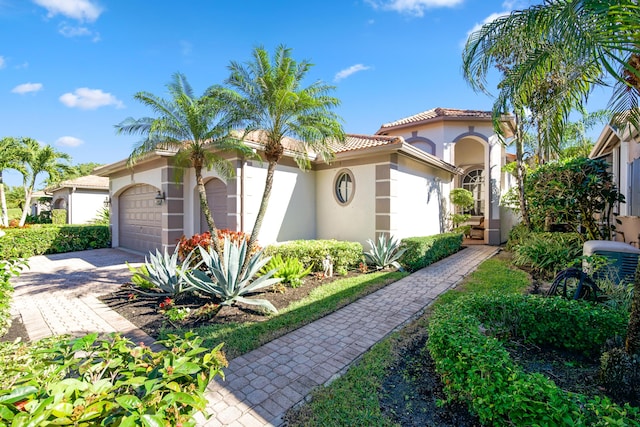 11556 Green Golf Ln, Boynton Beach, FL 33437 - mediterranean / spanish home featuring stucco siding, a garage, decorative driveway, and a tile roof
