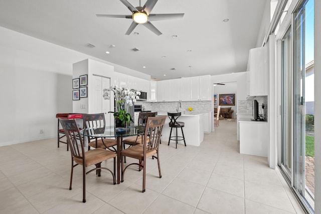 dining space with ceiling fan and light tile patterned floors