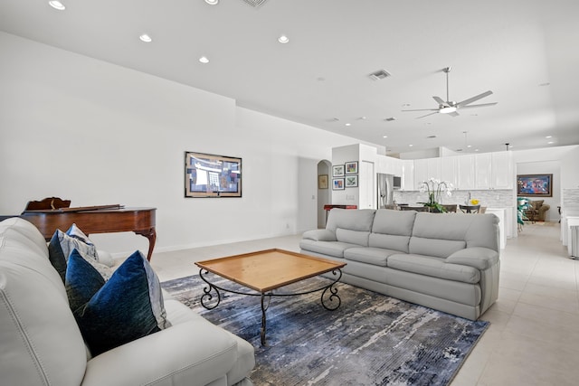 living room with ceiling fan and light tile patterned floors