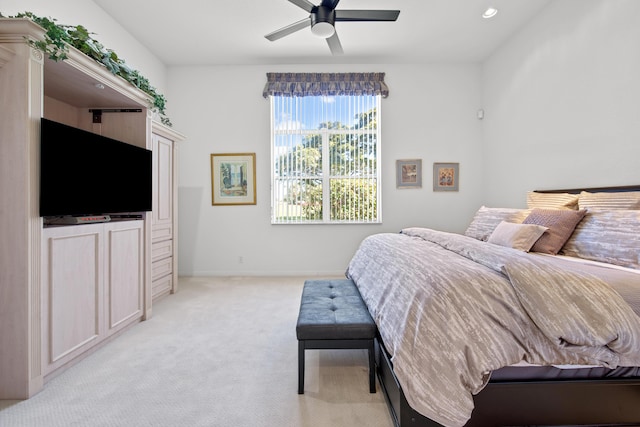 bedroom featuring ceiling fan and light carpet