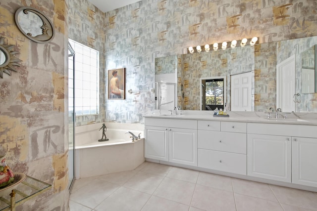 bathroom featuring vanity, tile patterned floors, and a bathtub