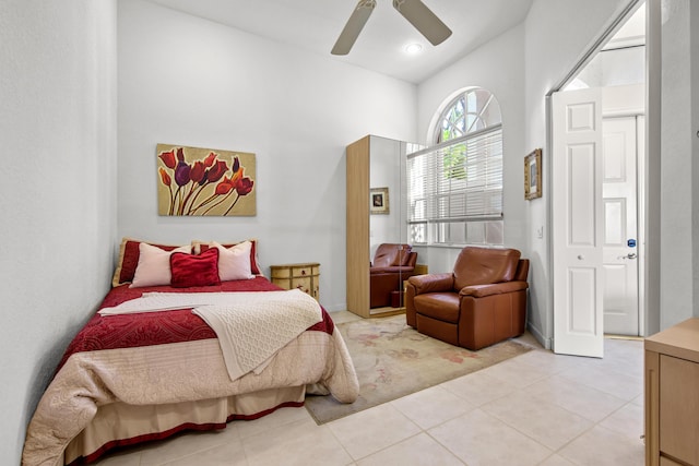 tiled bedroom featuring ceiling fan and vaulted ceiling