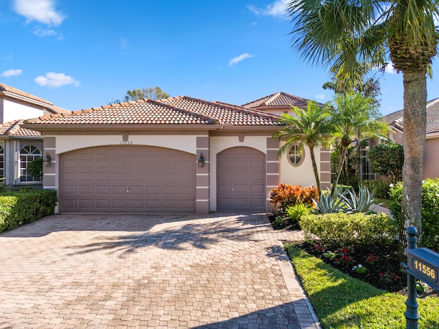 mediterranean / spanish-style home with a garage