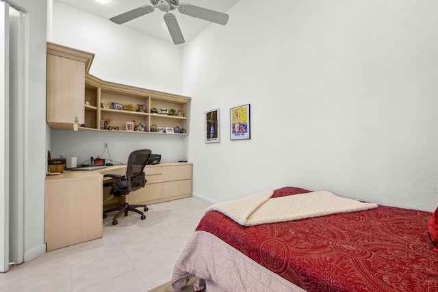 bedroom with ceiling fan and built in desk