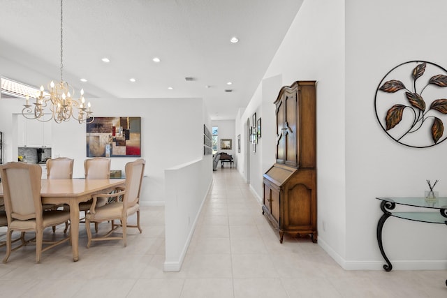 tiled dining space featuring a chandelier