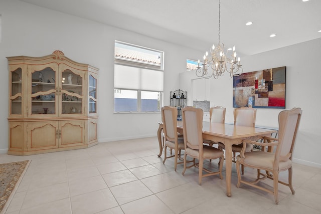 tiled dining area with a chandelier