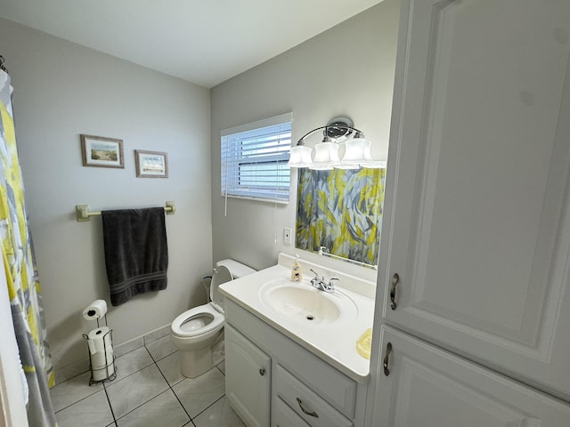 bathroom featuring tile patterned flooring, vanity, and toilet