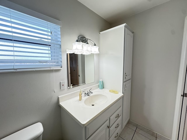 bathroom featuring tile patterned floors, vanity, and toilet