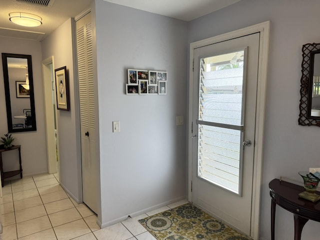 doorway featuring light tile patterned flooring