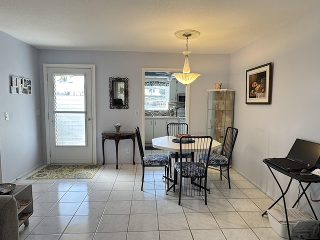 dining space featuring light tile patterned floors