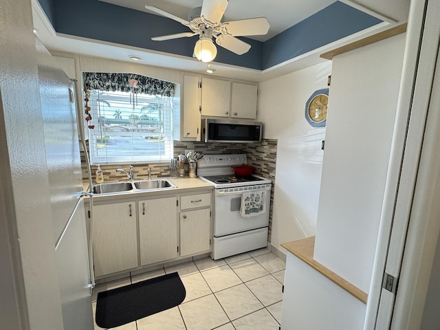 kitchen with backsplash, sink, electric range, ceiling fan, and light tile patterned flooring