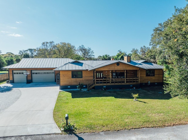 view of front of house with a garage and a front lawn