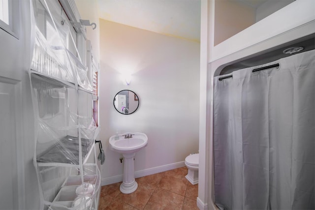 bathroom with tile patterned flooring and toilet