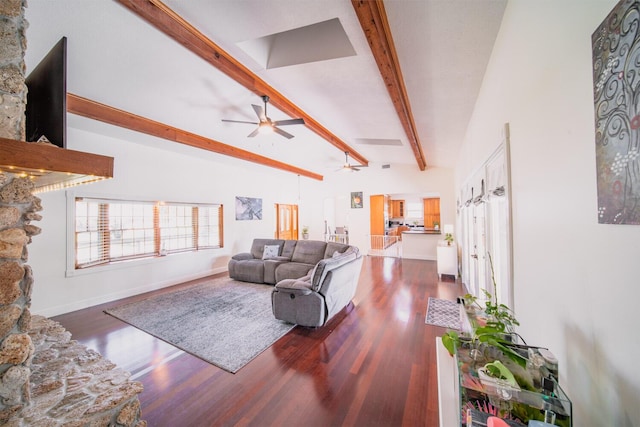 living room with hardwood / wood-style floors, lofted ceiling with beams, and ceiling fan