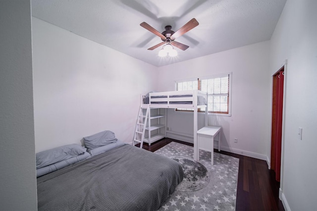 bedroom featuring ceiling fan and dark hardwood / wood-style flooring