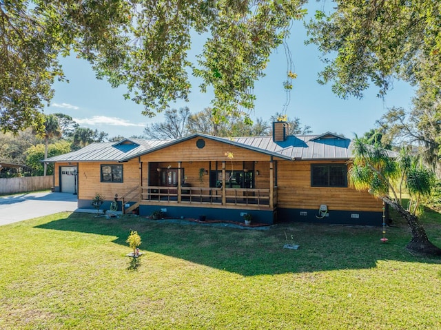 view of front of property featuring a garage, covered porch, and a front yard