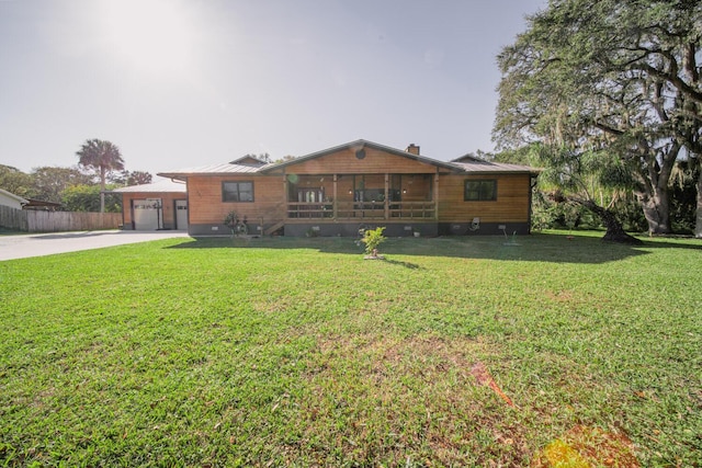 back of property featuring a sunroom and a yard