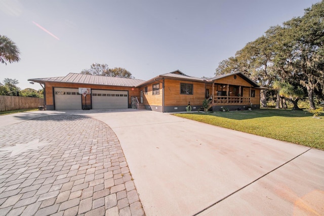 single story home featuring a front lawn and a garage