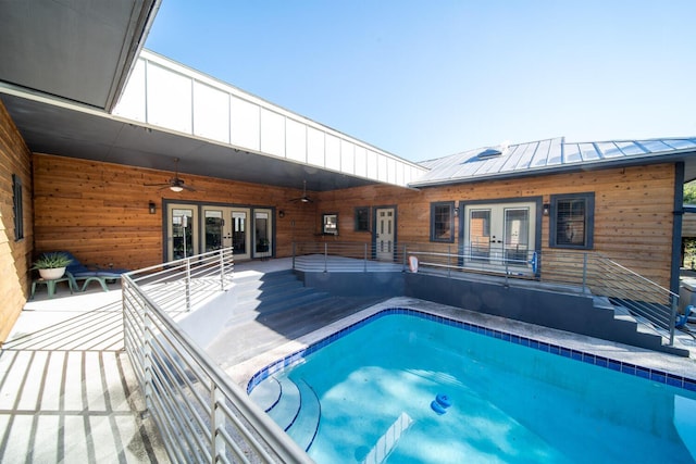 view of pool featuring ceiling fan and french doors