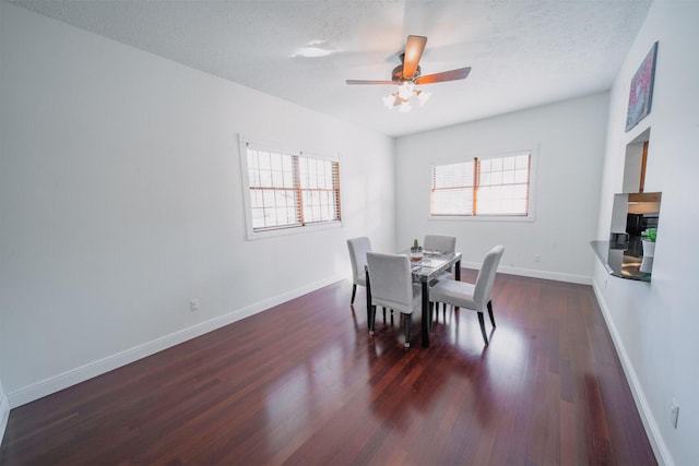 dining space featuring ceiling fan, dark hardwood / wood-style flooring, and a textured ceiling