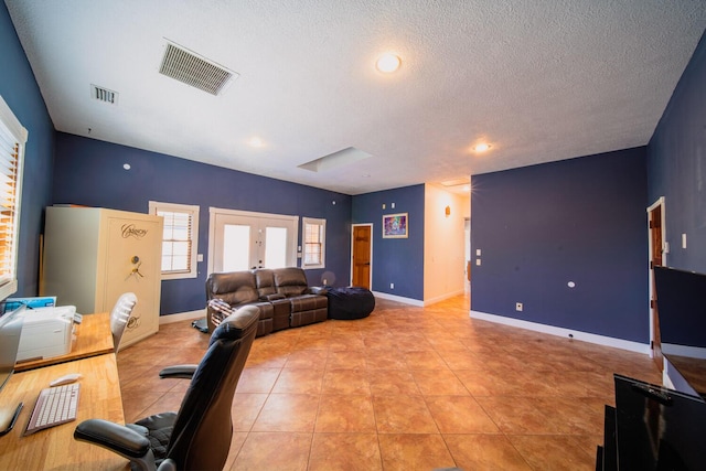 living room featuring french doors, a textured ceiling, and light tile patterned floors