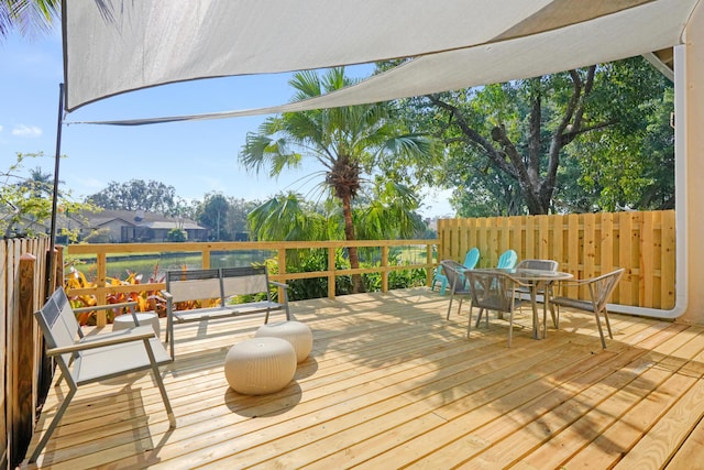 wooden deck with a hot tub