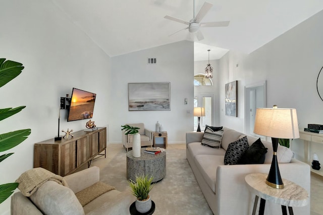 living room with lofted ceiling, ceiling fan with notable chandelier, and light carpet