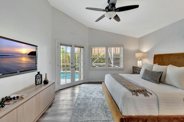 bedroom featuring ceiling fan, vaulted ceiling, light hardwood / wood-style floors, access to outside, and french doors