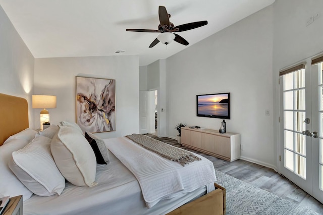 bedroom with french doors, ceiling fan, lofted ceiling, and light hardwood / wood-style floors