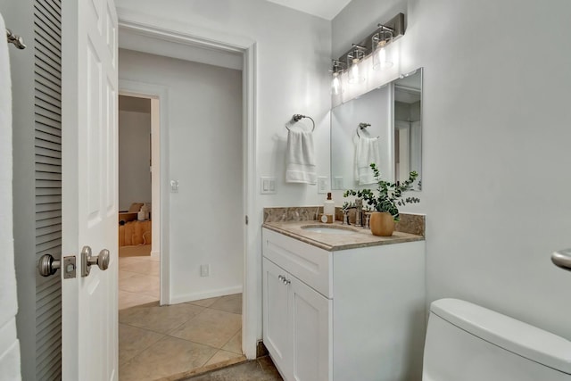 bathroom with vanity, toilet, and tile patterned flooring