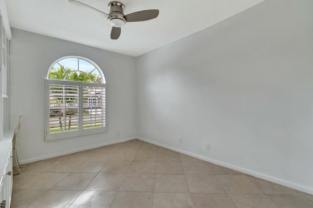 unfurnished room with ceiling fan and light tile patterned floors