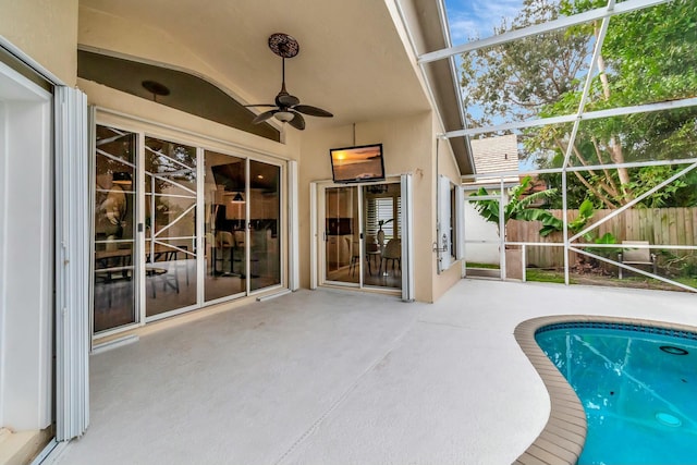 view of swimming pool featuring a patio, a lanai, and ceiling fan