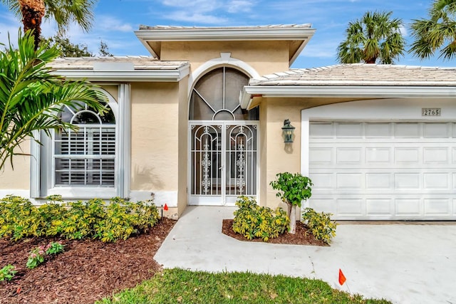 view of exterior entry with a garage