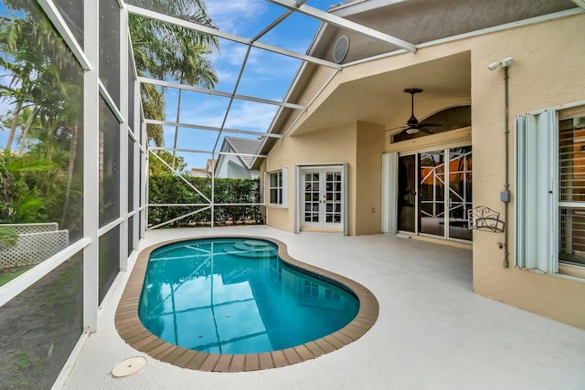 view of pool with a lanai, a patio, and ceiling fan