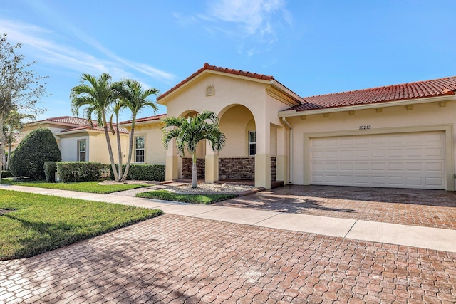 mediterranean / spanish-style home with a garage