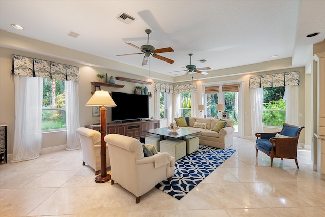 living room featuring ceiling fan and light tile patterned floors