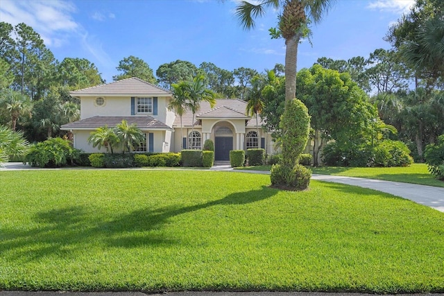 mediterranean / spanish-style home with a front lawn