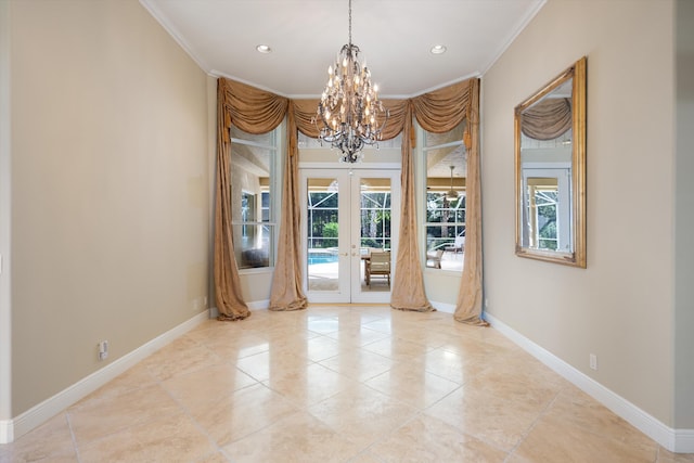 empty room with a notable chandelier, crown molding, and french doors