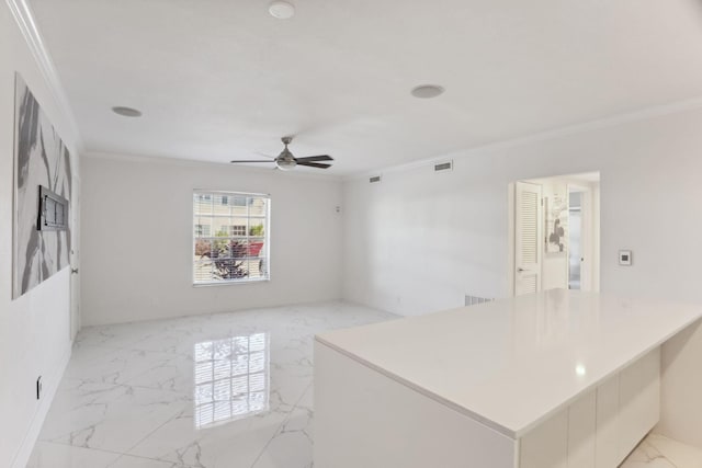 spare room with crown molding and ceiling fan