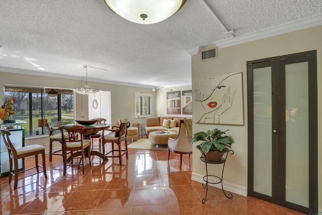 tiled dining room featuring french doors, a textured ceiling, and ornamental molding