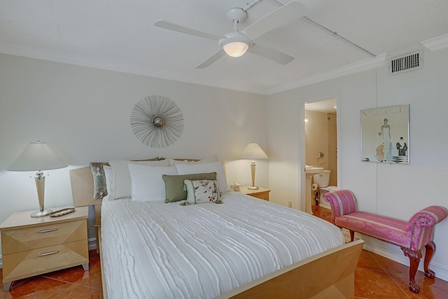 tiled bedroom featuring ceiling fan, crown molding, and ensuite bath