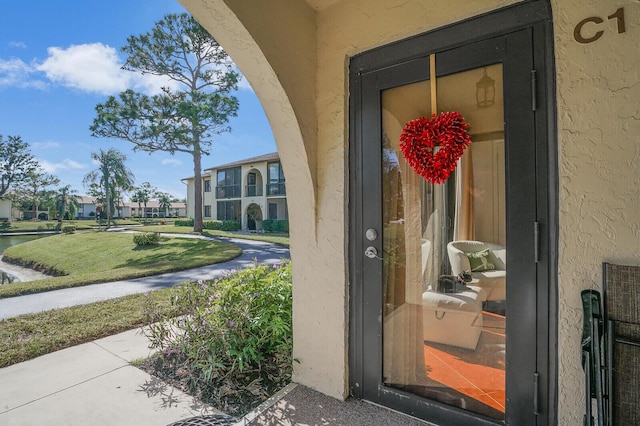 entrance to property featuring a yard